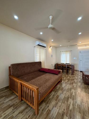 a living room with a couch and a dining room at SANTA MARIA HOSTEL MUNROE ISLAND in Munroe Island
