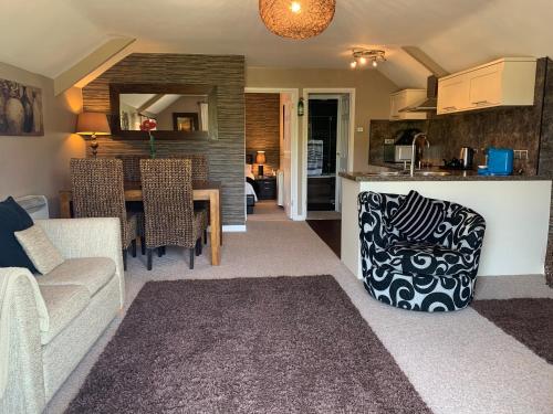 a living room and kitchen with a couch and a table at Beaconsfield Farm in Wells