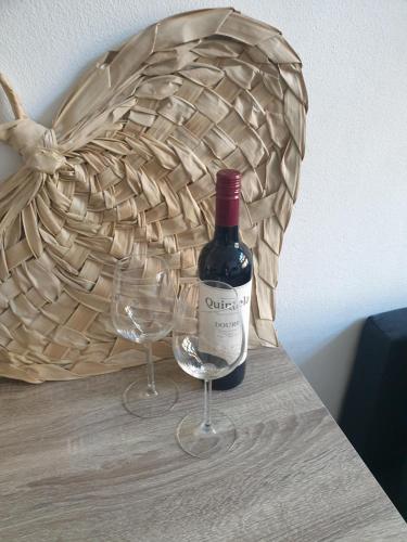 a bottle of wine and two wine glasses on a table at @Salland in Zwolle