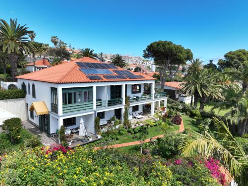 a house with solar panels on the roof at Villa Erika Madeira in Caniço