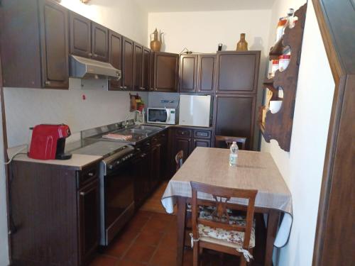 a kitchen with wooden cabinets and a table and a counter at DAM Home in Modena