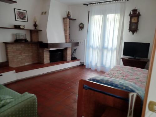 a living room with a fireplace and a bed at DAM Home in Modena