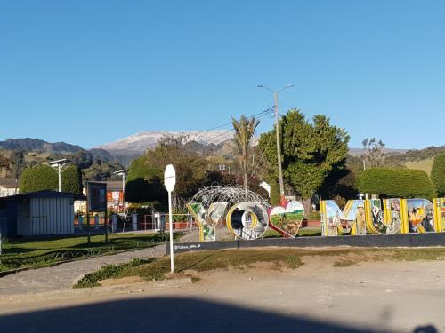 a sign that says love in a park at Hostal Perla Del Norte in Murillo