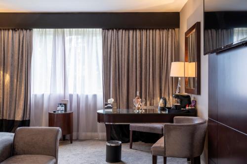 a hotel room with a desk in a room at Derwent Manor Boutique Hotel in Consett