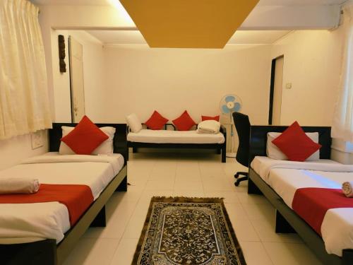 a hotel room with two beds and a couch at Piller homes 3 BHK Pune in Pune