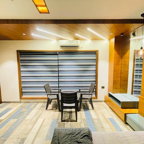 a dining room with a table and chairs at Nisarg’s stays in Ahmedabad