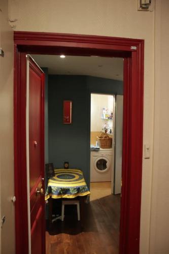 a door leading to a room with a table in it at Sunny Serenity: 2-room Charm in Boulogne in Boulogne-Billancourt