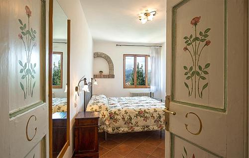 a bedroom with two beds and a door with flowers on it at Gorgeous Home In Ascoli Piceno With Wifi in Ascoli Piceno