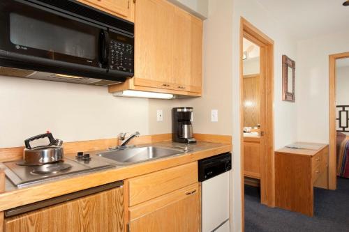 a kitchen with a sink and a microwave at River Run Village by Keystone Resort in Keystone