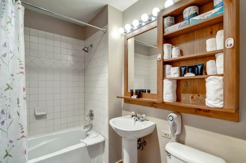 a bathroom with a sink and a toilet and a mirror at River Run Village by Keystone Resort in Keystone