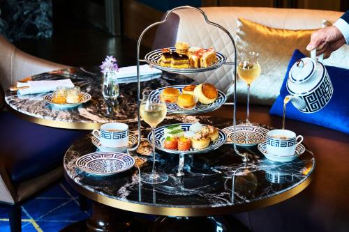 a table with two plates of food and glasses of wine at The St. Regis Osaka in Osaka