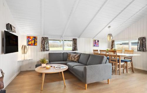 a living room with a couch and a table at Holiday Home Solbjergvej Sydals Denm in Høruphav