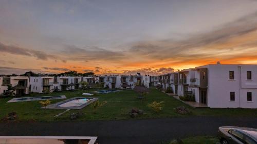 a view of an apartment complex at sunset at Haven Green Village in Grand Gaube