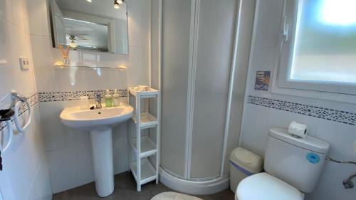 a white bathroom with a sink and a toilet at B&B Casa Sardonyx in Calpe