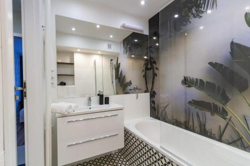 a bathroom with a white tub and a sink and a bath tub at South House in Włocławek