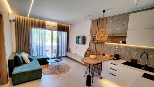 a kitchen and living room with a couch and a table at Aelia Apartments in Makry Gialos