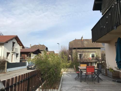 a patio with a table and chairs in a house at Chambre Sallanches in Sallanches