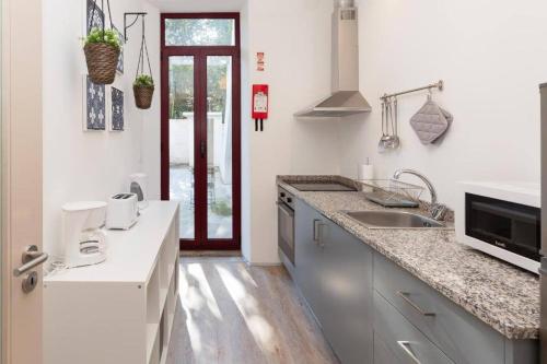 a kitchen with a sink and a counter top at Boho House Terrace in Porto