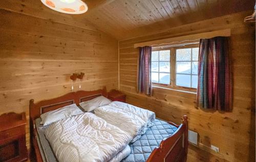 a bedroom with a bed in a log cabin at Cozy Home In Venabygd With Sauna in Venabygd