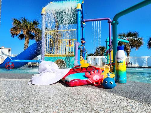 a childs toy on the ground in front of a playground at 3 BR Direct Oceanfront Condo Wyndham Ocean Walk Resort - Daytona Funland 1023 in Daytona Beach