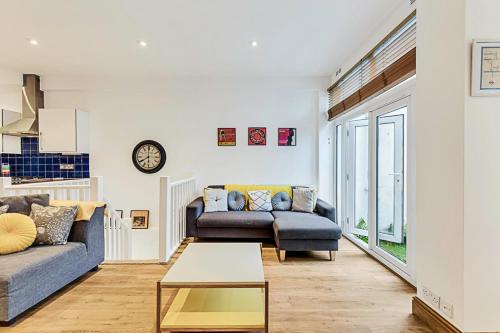 a living room with a couch and a table at Gem on the Rye in London