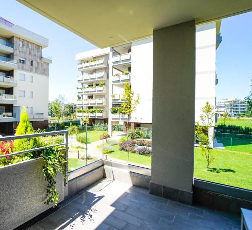 an apartment balcony with a view of a park at New Living Milano in Gorgonzola