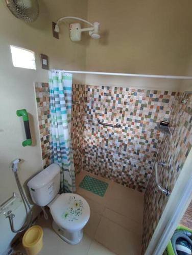 a small bathroom with a toilet and a shower at Caridade Loft in Monte das Gameleiras