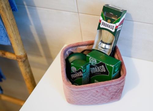a basket with a toothbrush and a tooth paste at New Living Milano in Gorgonzola