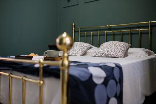 Cama con manta y almohadas azules y blancas en Bologna Travel Suite, en Bolonia