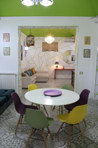 uma sala de estar com mesa e cadeiras em Green House Apartment al Massimo em Palermo