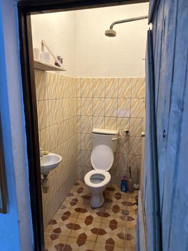 La petite salle de bains est pourvue de toilettes et d'un lavabo. dans l'établissement Diani cozy studio apartment, à Ukunda