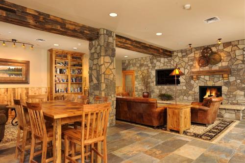 a living room with a table and a fireplace at Jackpine & Black Bear Condominiums by Keystone Resort in Keystone