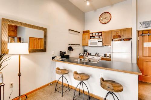 a kitchen with a counter and two stools at Jackpine & Black Bear Condominiums by Keystone Resort in Keystone