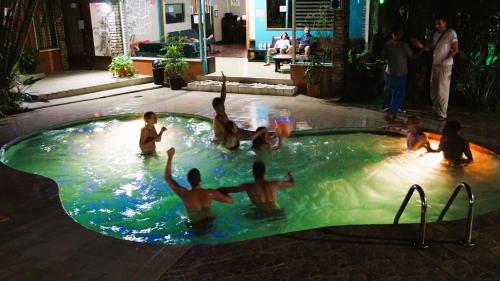 a group of people playing in a swimming pool at Costa Rica Backpackers in San José