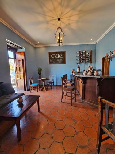 a living room with a couch and a table and chairs at Casa Hibiscus Boutique Hotel in Cuenca