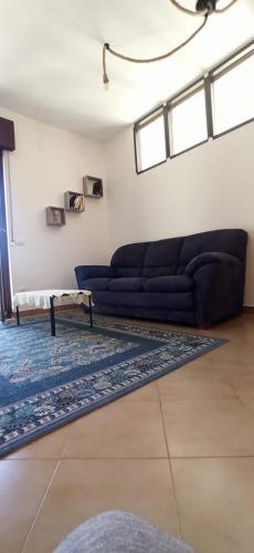 a living room with a couch and a rug at Natura Affittacamere in Campobasso