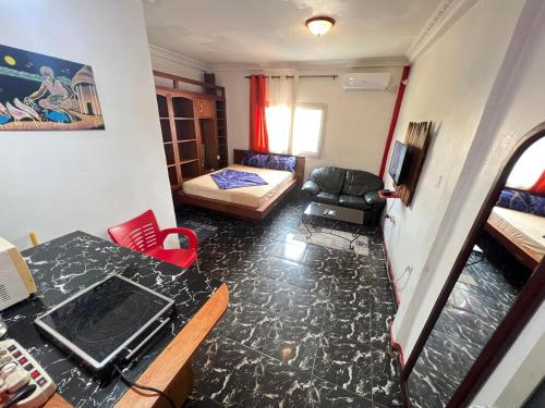 a small living room with a table and a couch at The Yafé Bastos 5 in Yaoundé