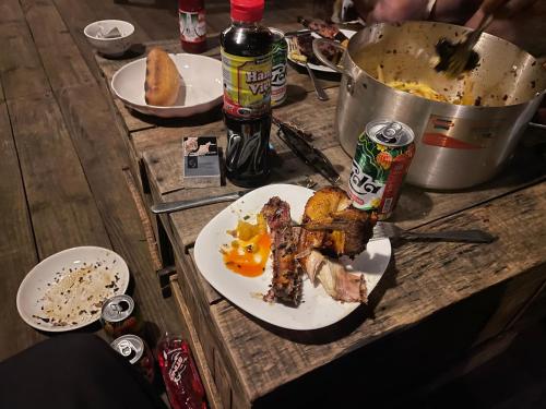 a wooden table with a plate of food on it at Vuglamping in Hue