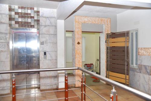 a hallway with a door in a building at Akash Avenue Soniya Service Apartment in Tirunelveli