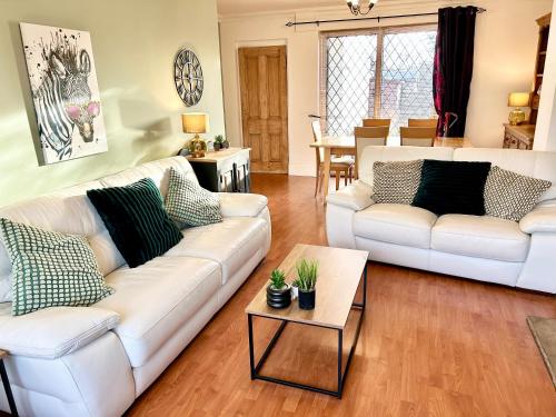 a living room with two white couches and a table at Beautiful 3 Bedroom House in Chester Le Street in Chester-le-Street