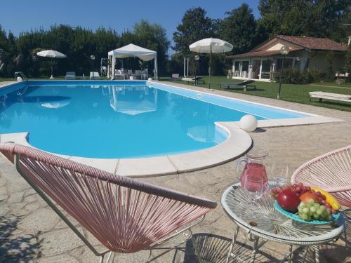 una mesa con un bol de fruta junto a una piscina en Villa Fioccomare, en Camaiore