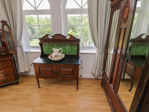 a room with a dresser with a bowl on top of it at The Power House in Loftus