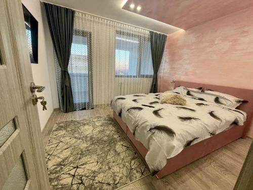 a bedroom with a bed and a window and a door at D&D New Residence in Piteşti