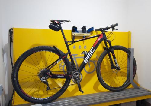 a bike is sitting on a yellow bench at Acquarello Swiss Quality Hotel in Lugano