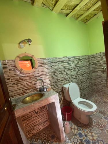 a bathroom with a sink and a toilet in it at riad jnane imnane in Tamguist