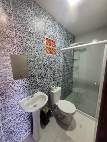 a bathroom with a toilet and a sink and a shower at CHALES DA SERRA in Bananeiras