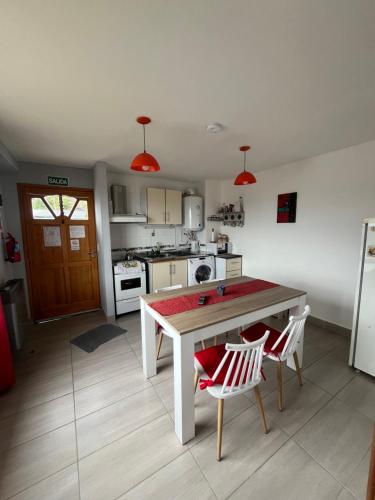 a kitchen with a table and two chairs in it at Ushuaia aparts Depto 2 in Ushuaia