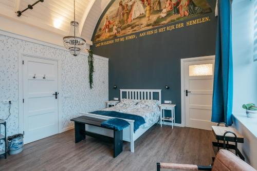 a bedroom with a bed and a painting on the wall at Klooster Achthuizen in Achthuizen