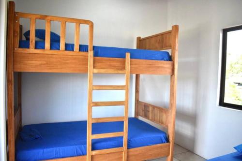 two bunk beds in a room with blue sheets at Alojamiento Casmar cerca de playas in Palma