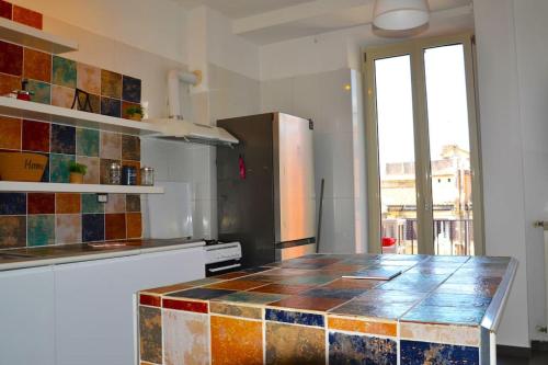 a kitchen with a counter with colorful tiles on it at Rome Appartement in Rome